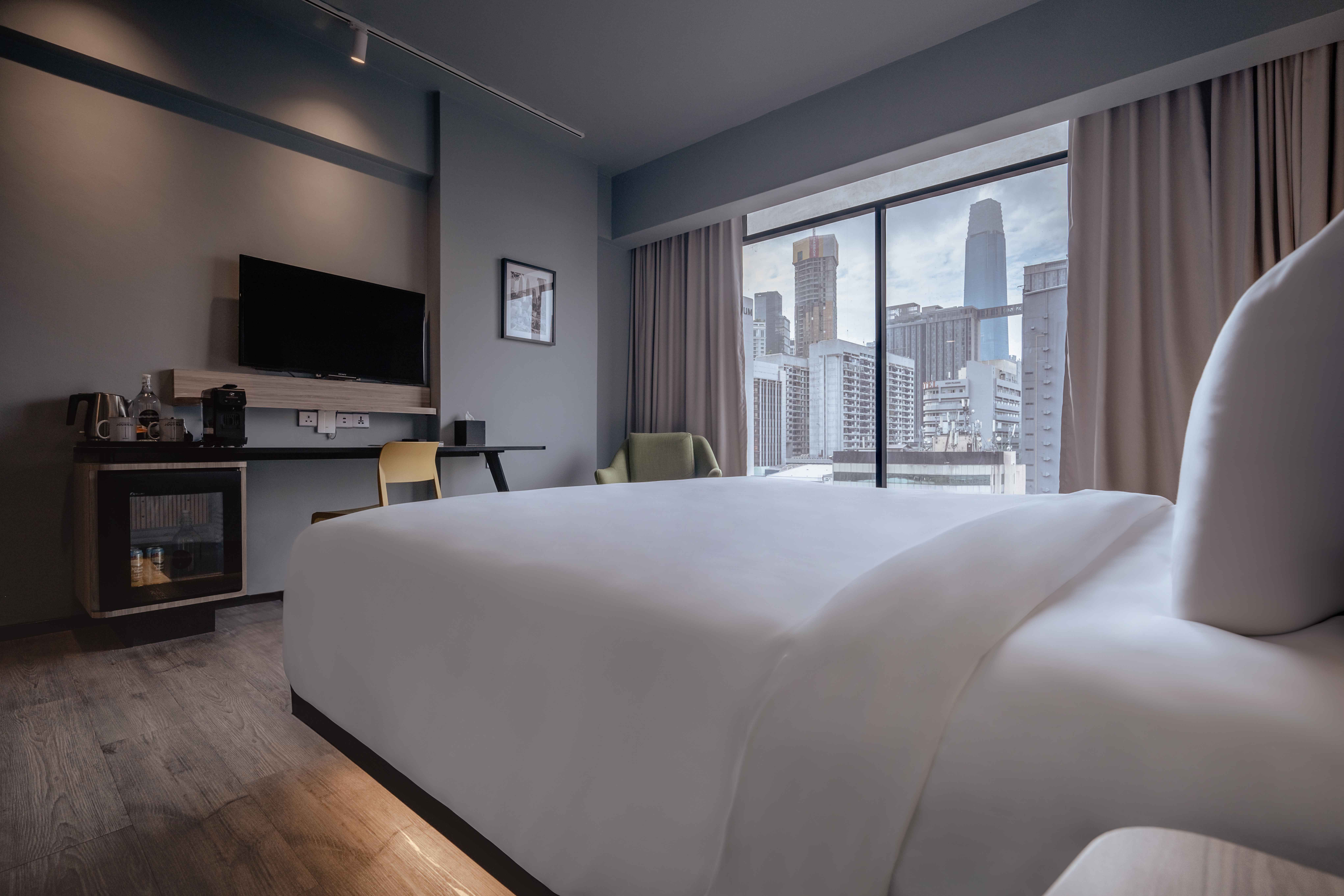 Deluxe Triple room at KL Journal Hotel with daytime city views